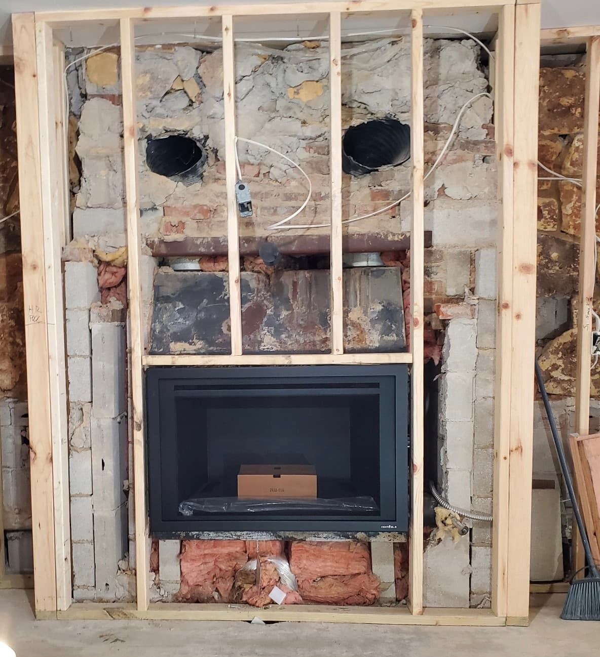 New gas insert set into an old brick chimney that has been framed out for a full rebuild